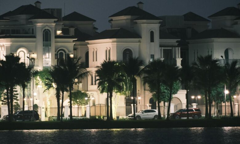a large white building with palm trees in front of it