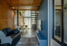 Modern living room with wooden walls and stairs